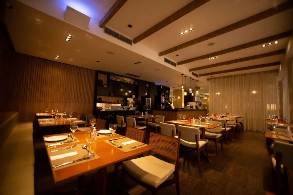 Set tables in a warmly lit restaurant dining room